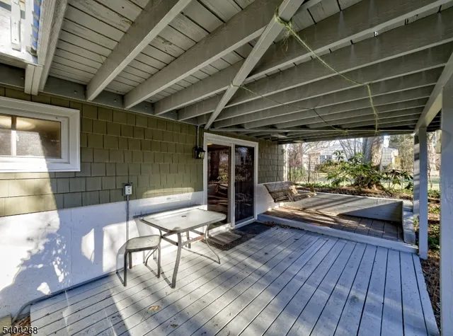 a view of a patio with table and chairs with wooden floor