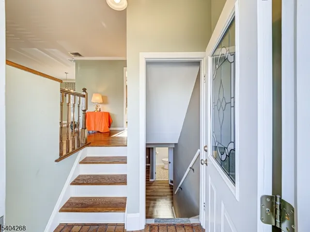 a view of staircase with railing and white walls