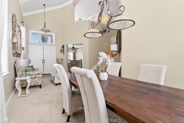 a dining room with furniture and wooden floor