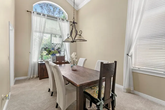 a view of a dining room with furniture and a window