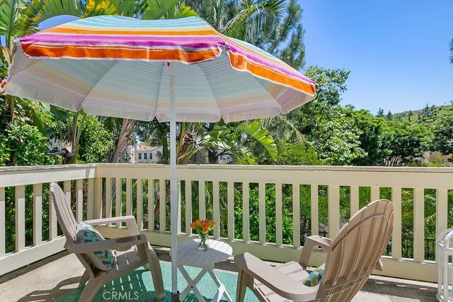 a view of a chair and tables in the balcony
