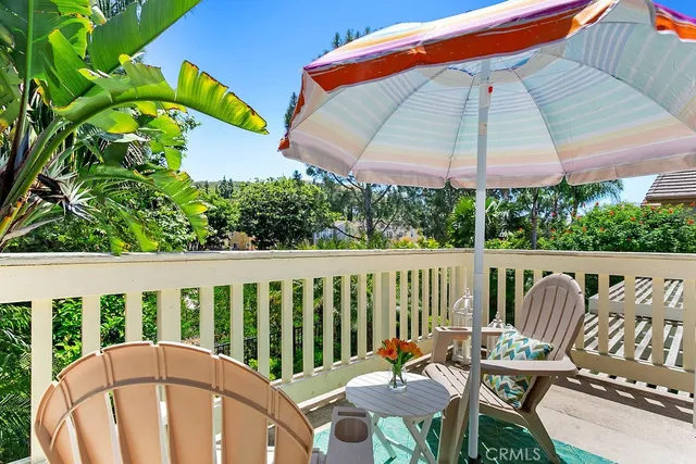 a view of a chair and table in the balcony