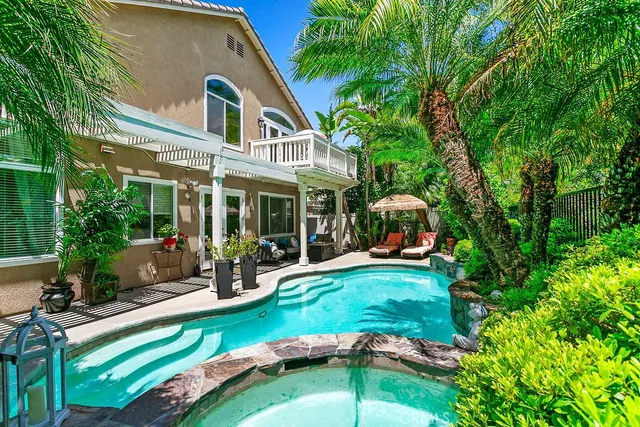 a view of a house with backyard sitting area and garden