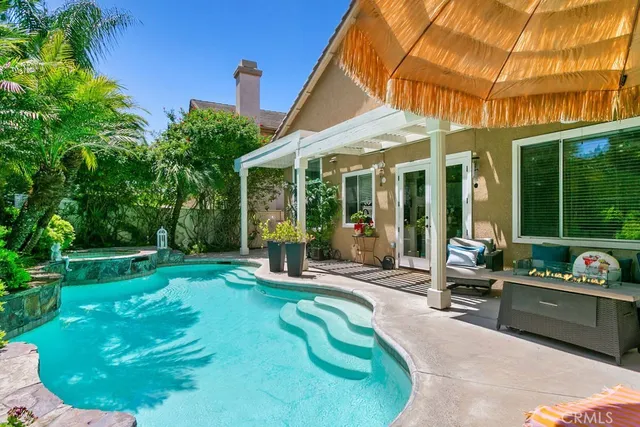 a view of a house with backyard porch and sitting area