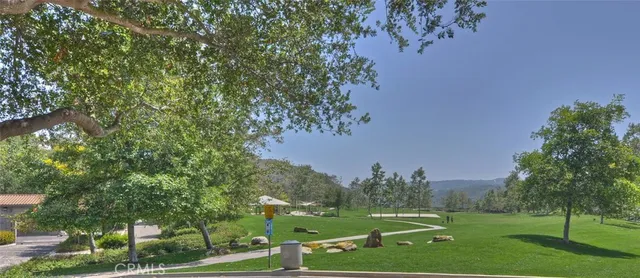 a view of a yard with wooden fence