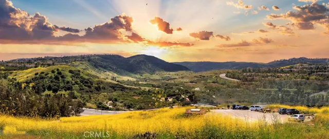 a view of a mountain range with lush green forest