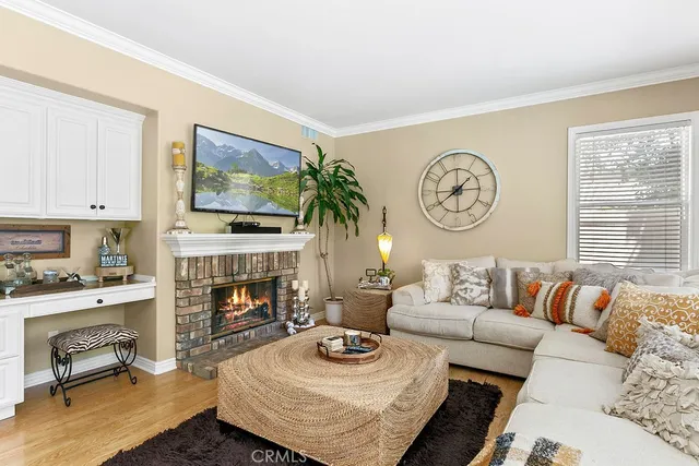 a living room with furniture a fireplace and a window