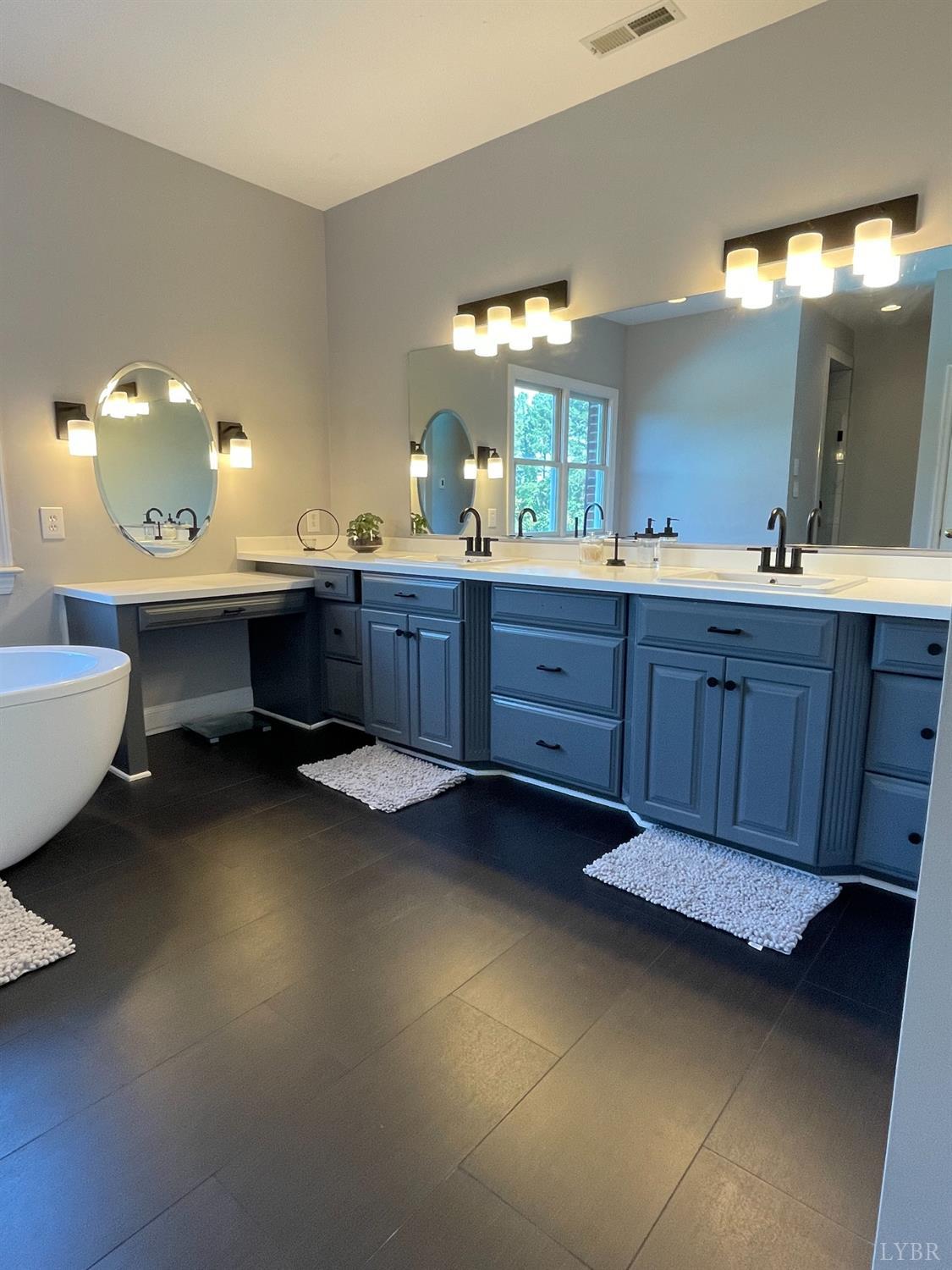 798 High Peak Road Monroe, VA 24574 - Photo 40 of 96 a bathroom with a double vanity sink and a mirror