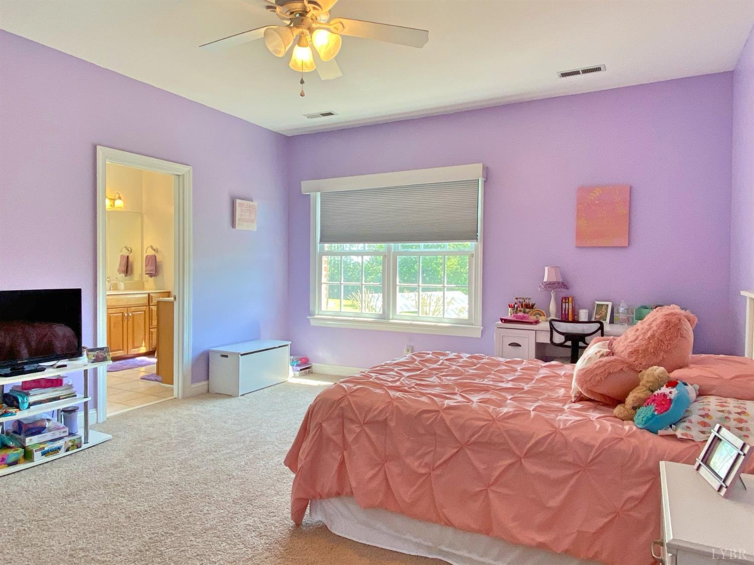 798 High Peak Road Monroe, VA 24574 - Photo 49 of 96 a bedroom with a bed and a flat screen tv