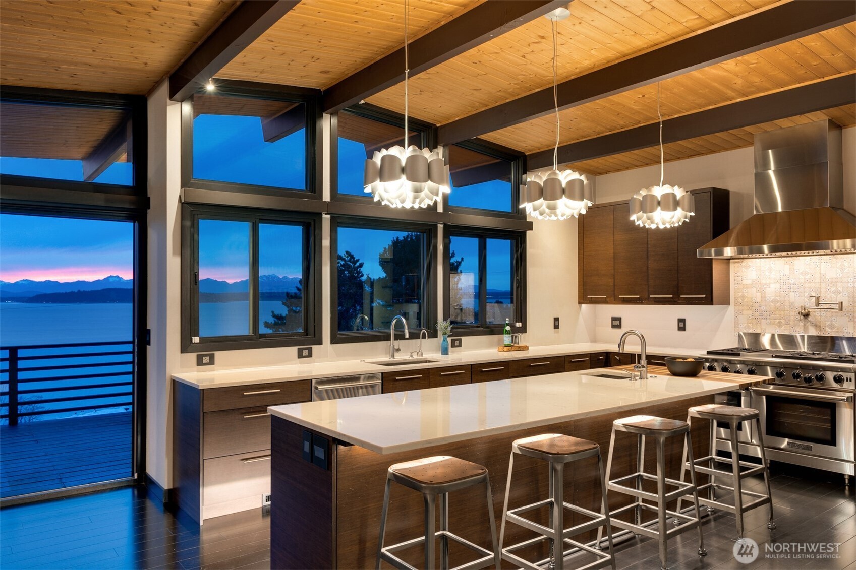 3831 58th Avenue Southwest Seattle, WA 98116 - Photo 6 of 40 a dinning table and chairs in the kitchen next to a building