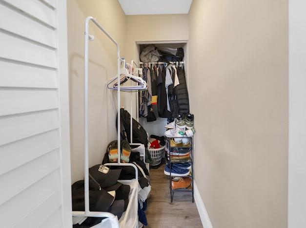 19426 Colorado Circle Boca Raton, FL 33434 - Photo 11 of 32 a view of walk in closet with clothes and shoes