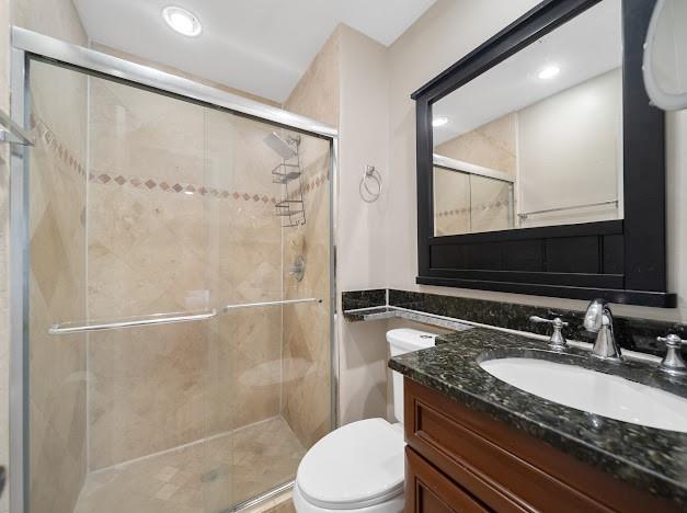 19426 Colorado Circle Boca Raton, FL 33434 - Photo 12 of 32 a bathroom with a granite countertop sink toilet and shower