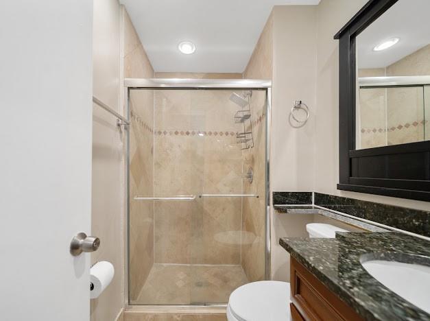 19426 Colorado Circle Boca Raton, FL 33434 - Photo 13 of 32 a bathroom with a granite countertop sink toilet and shower