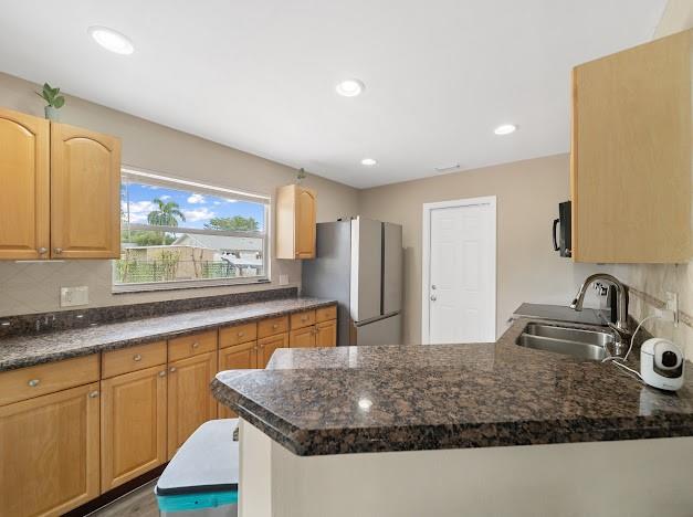 19426 Colorado Circle Boca Raton, FL 33434 - Photo 14 of 32 a kitchen with stainless steel appliances granite countertop a sink a stove and a refrigerator