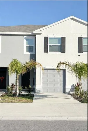 a view of a house with a yard and plants