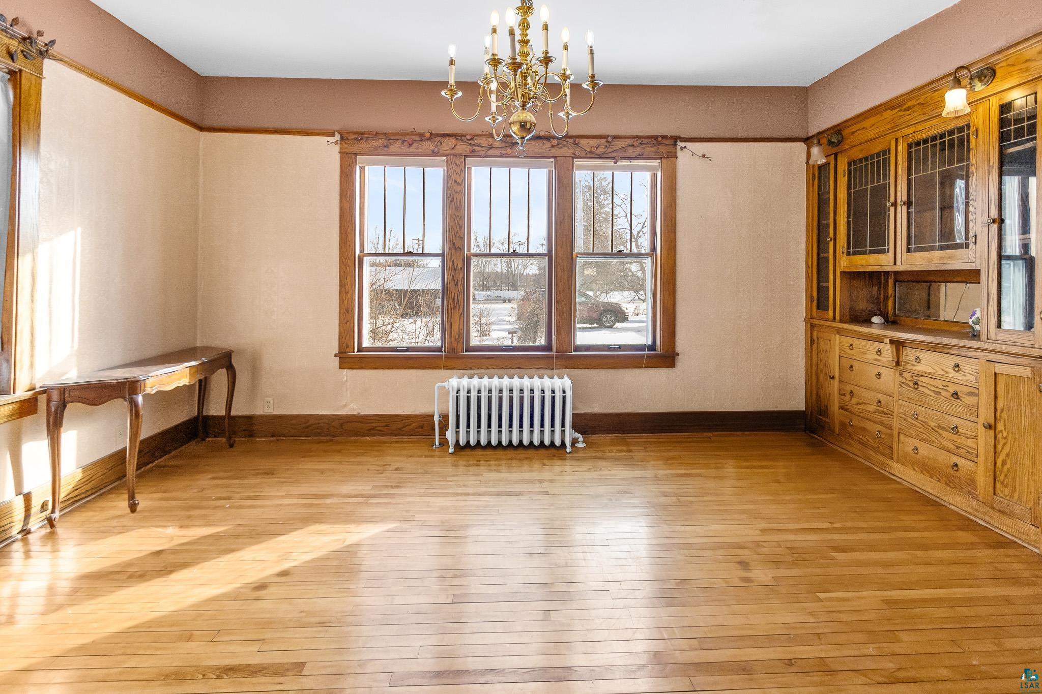 6494 School Street Finlayson, MN 55735 - Photo 5 of 31 Unfurnished dining area featuring radiator, suspended lighting, and light wood-style flooring