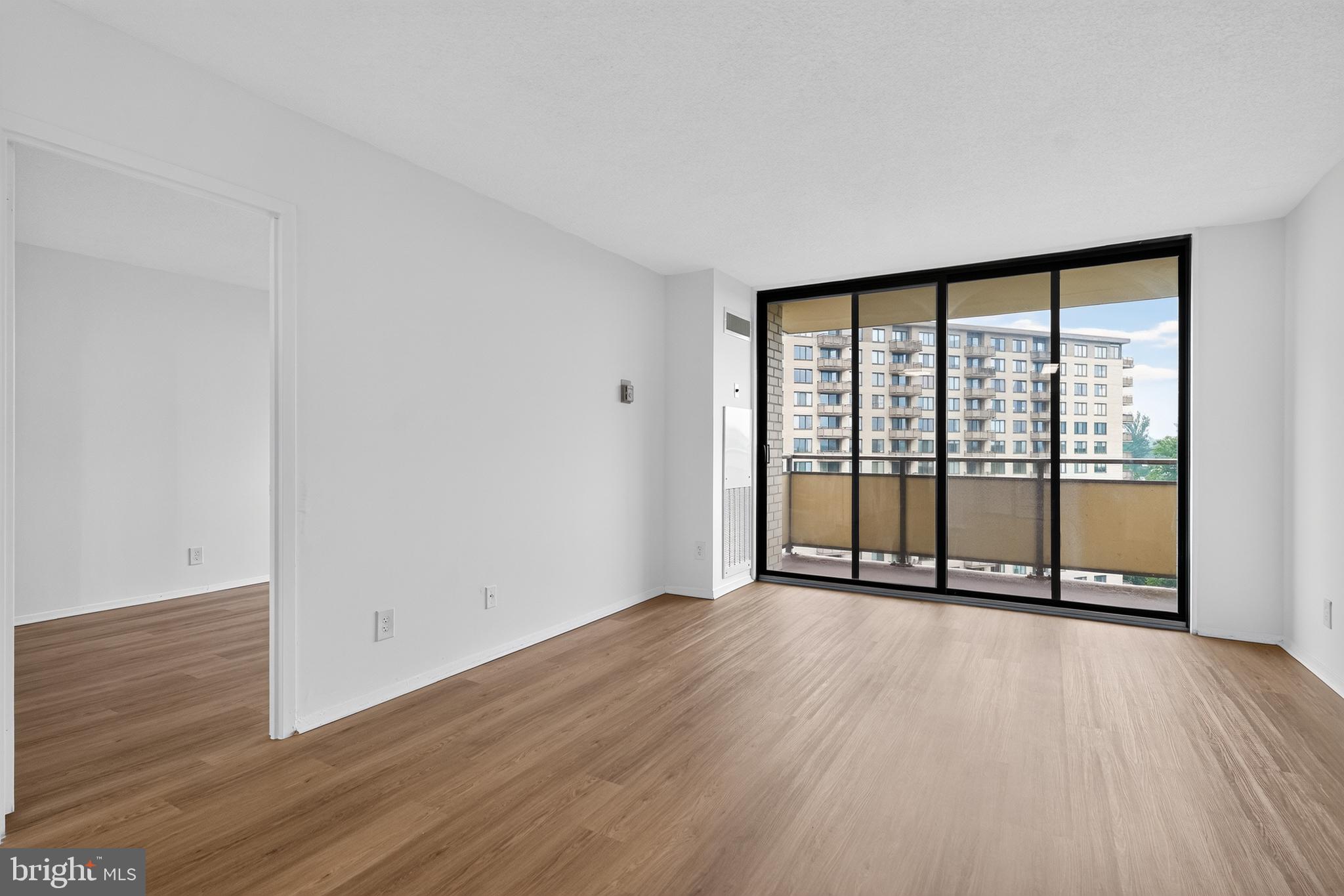 5225 Pooks Hill Road, Unit 1302N Bethesda, MD 20814 - Photo 8 of 19 a view of an empty room with wooden floor and a window