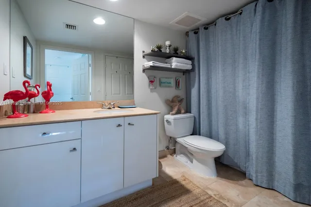 a kitchen with stainless steel appliances granite countertop a stove a microwave and a refrigerator