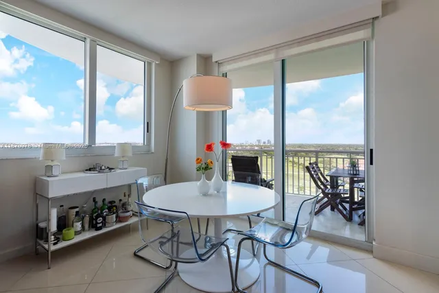 a kitchen with a stove a table and chairs in it