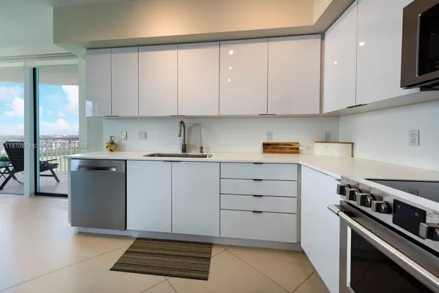 a kitchen with a table chairs refrigerator and cabinets