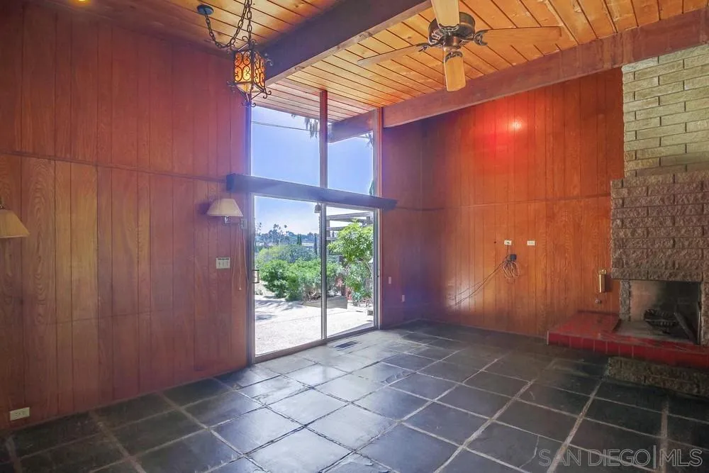 8680 Golf Drive Spring Valley, CA 91941 - Photo 16 of 70 a view of an empty room with a fireplace and a window