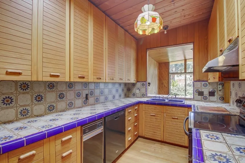 8680 Golf Drive Spring Valley, CA 91941 - Photo 20 of 70 a kitchen with stainless steel appliances a sink a stove and a window