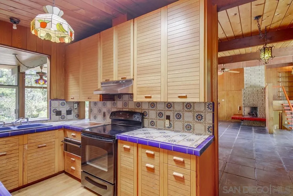 8680 Golf Drive Spring Valley, CA 91941 - Photo 22 of 70 a kitchen with stainless steel appliances granite countertop a stove sink and cabinets