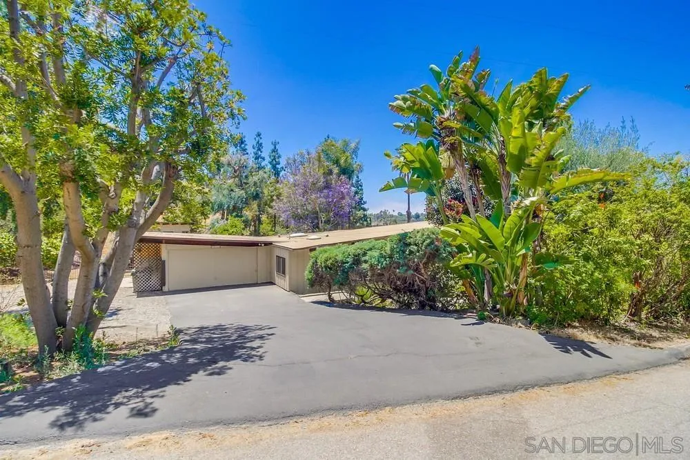 8680 Golf Drive Spring Valley, CA 91941 - Photo 63 of 70 a view of a white house with a yard and plant