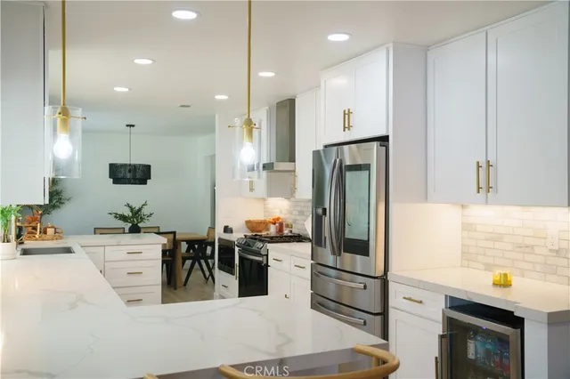 a kitchen with a potted plant on the sink and a granite counter tops