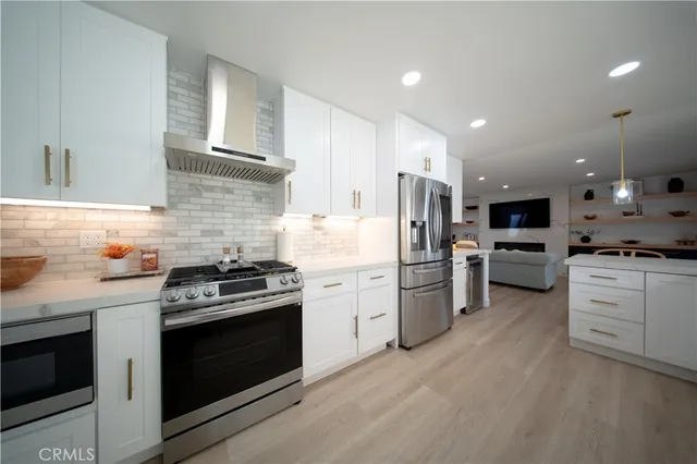 a kitchen with a stove and white cabinets