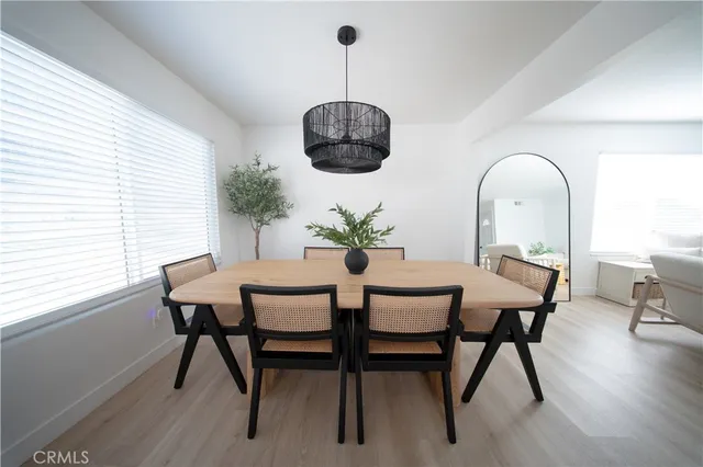 a dining room with furniture and wooden floor