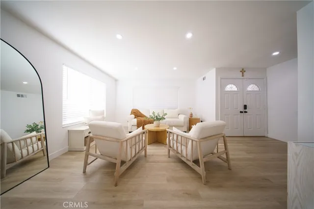 a living room with furniture window and a wooden floor