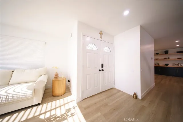 a view of a hallway with wooden floor and staircase