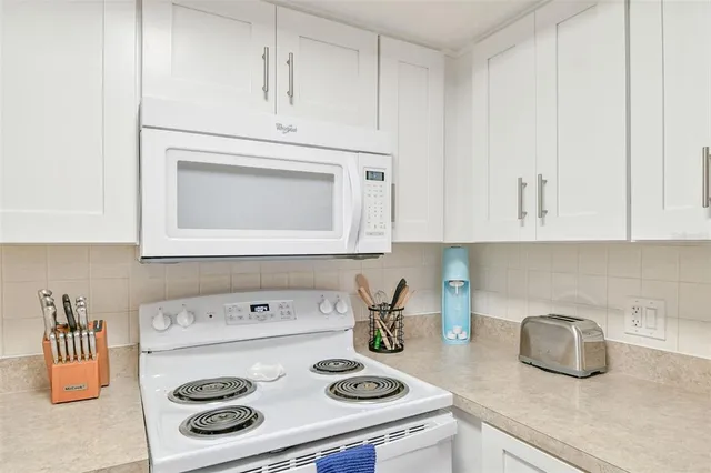 a kitchen with stainless steel appliances granite countertop a sink and cabinets
