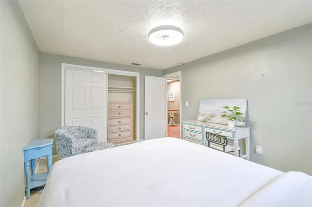 a bedroom with a bed and a chair