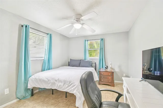 a bedroom with a bed and a chair