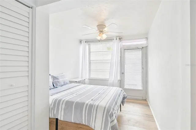 a bedroom with a bed and a wooden floor