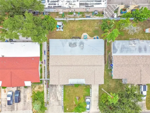 an aerial view of residential houses with outdoor space
