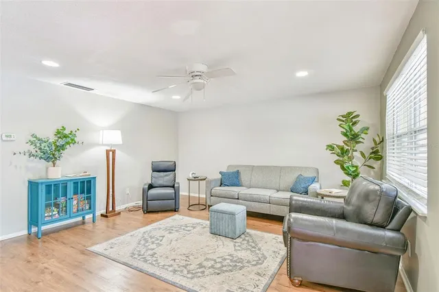 a living room with furniture and a potted plant