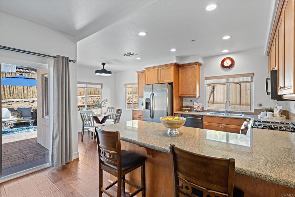 655 Dimaio Way Escondido, CA 92027 - Photo 14 of 46 a large kitchen with a table and chairs