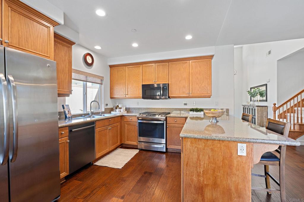 655 Dimaio Way Escondido, CA 92027 - Photo 15 of 46 a kitchen with stainless steel appliances granite countertop a stove top oven a sink and dishwasher