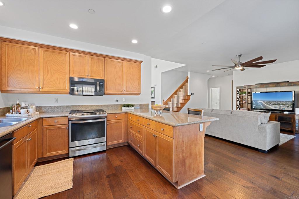 655 Dimaio Way Escondido, CA 92027 - Photo 16 of 46 a kitchen with stove a sink and a refrigerator