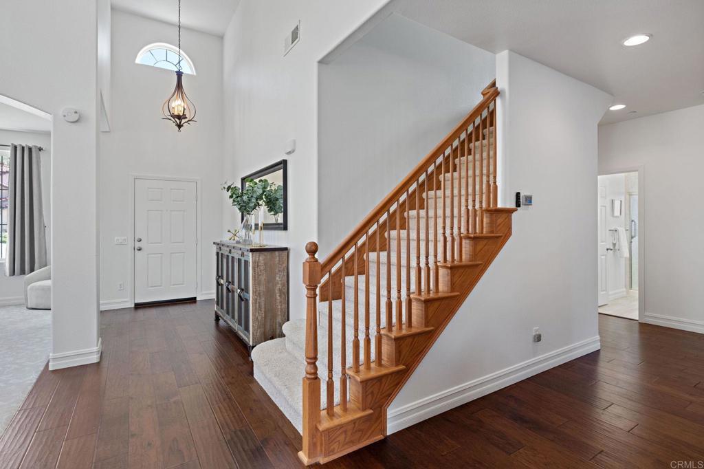 655 Dimaio Way Escondido, CA 92027 - Photo 24 of 46 a view of a hallway with wooden floor and stairs