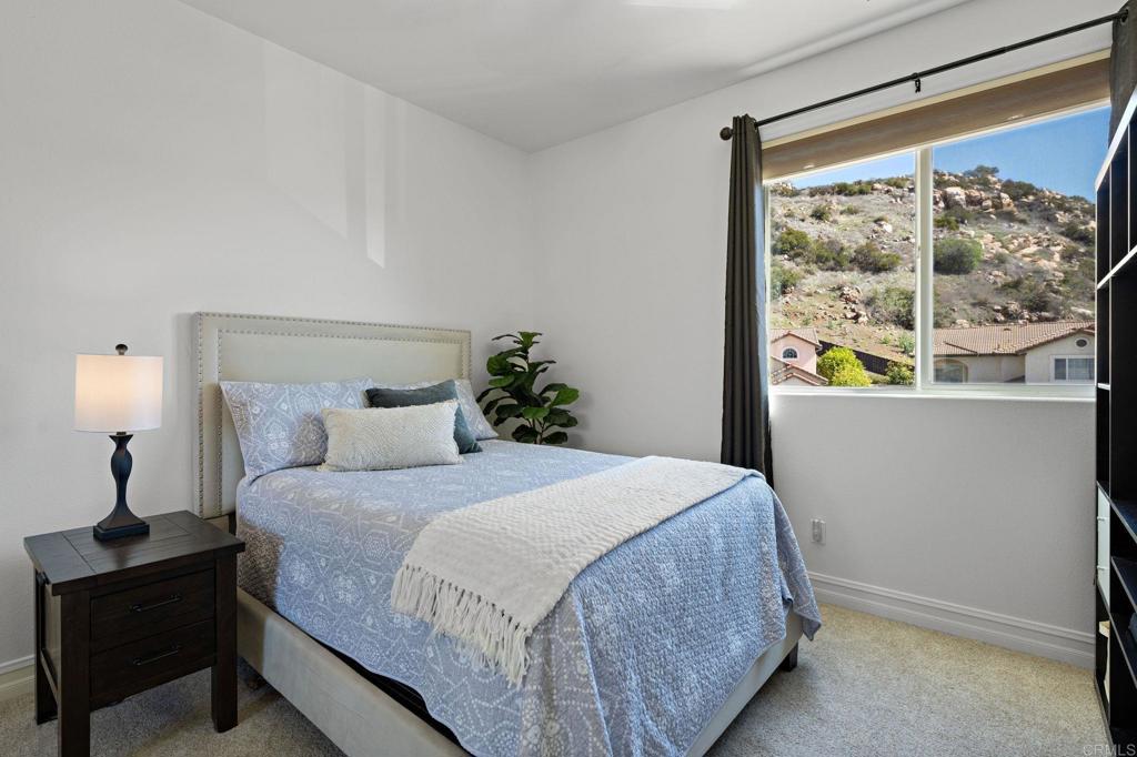 655 Dimaio Way Escondido, CA 92027 - Photo 26 of 46 a bedroom with a bed and a window