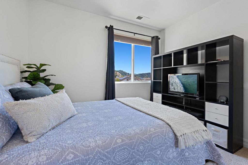 655 Dimaio Way Escondido, CA 92027 - Photo 27 of 46 a bedroom with a bed and a flat screen tv