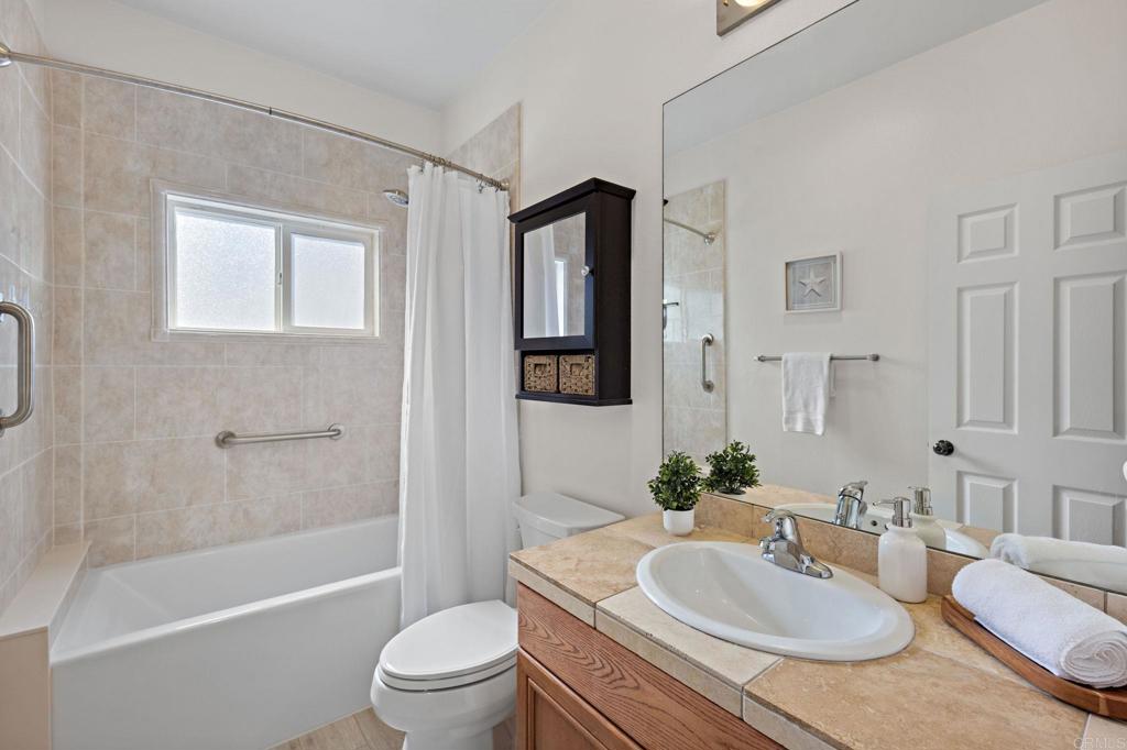 655 Dimaio Way Escondido, CA 92027 - Photo 31 of 46 a bathroom with a granite countertop sink toilet tub and shower