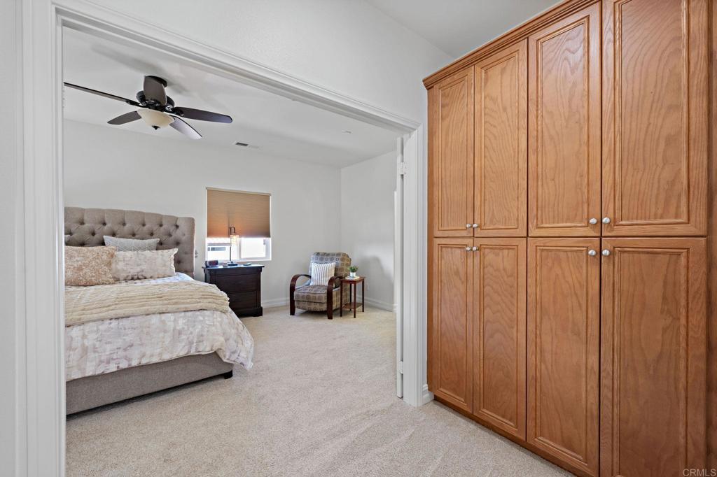 655 Dimaio Way Escondido, CA 92027 - Photo 32 of 46 a bedroom with a bed window and walk in closet