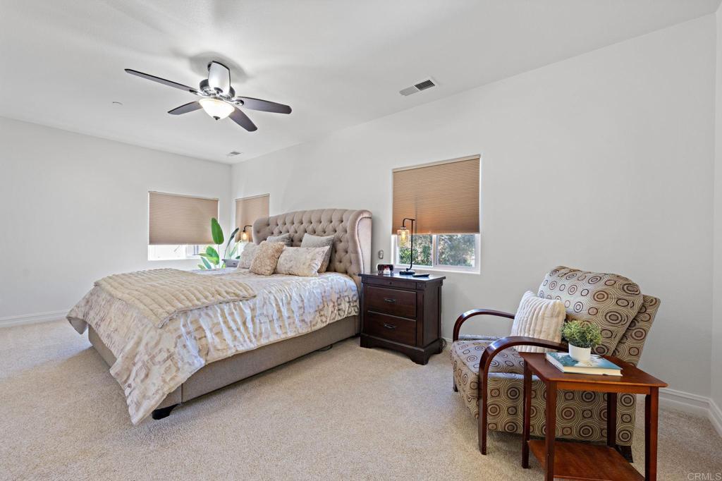 655 Dimaio Way Escondido, CA 92027 - Photo 34 of 46 a bedroom with a bed and a chandelier