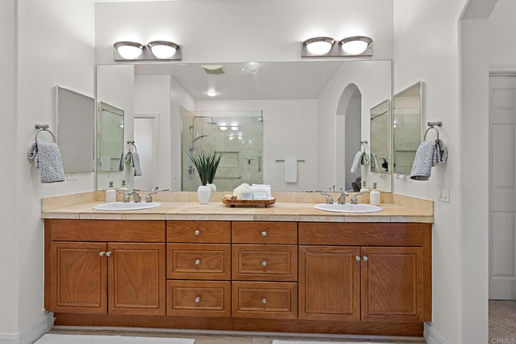 655 Dimaio Way Escondido, CA 92027 - Photo 38 of 46 a bathroom with a granite countertop sink a mirror and a