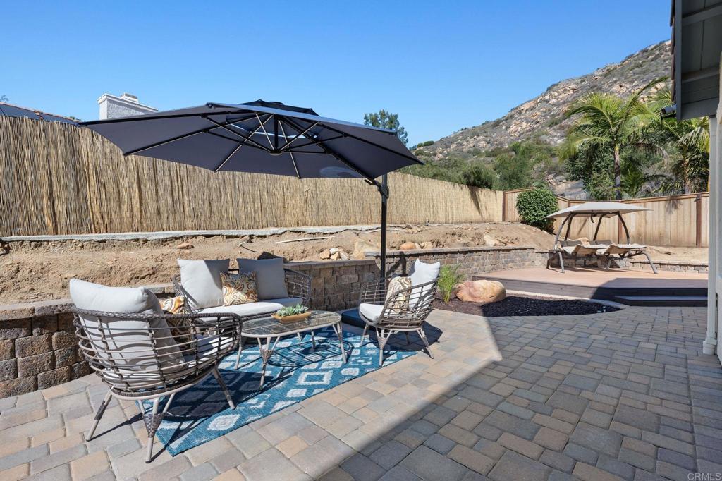 655 Dimaio Way Escondido, CA 92027 - Photo 41 of 46 a view of an outdoor sitting area with furniture and umbrella